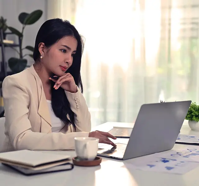 Woman looks into the laptop